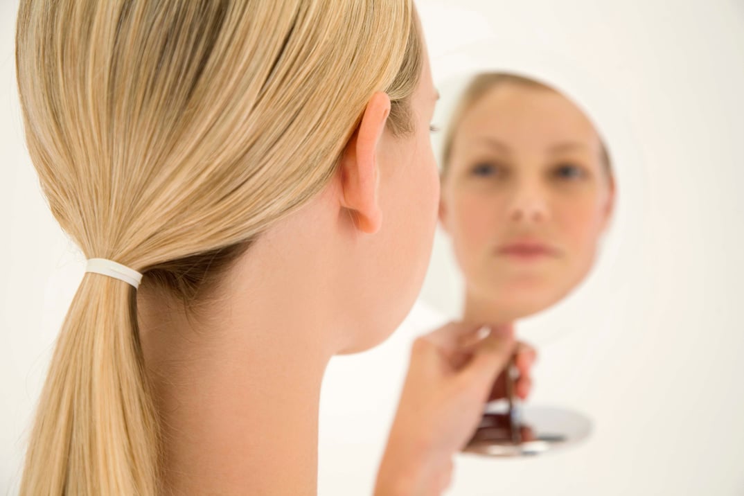 Woman looking in mirror